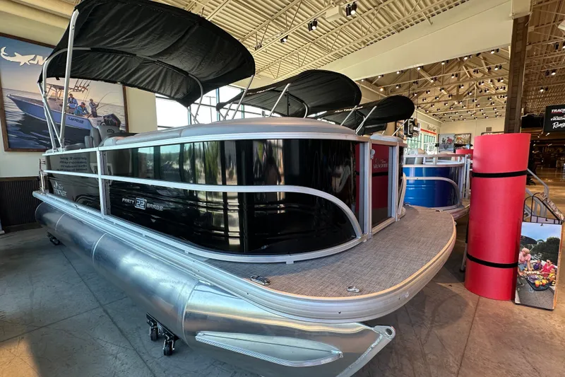 The Image of 2026 Sun Tracker Party Barge 22 XP3 pontoon boat displayed indoors. - 1