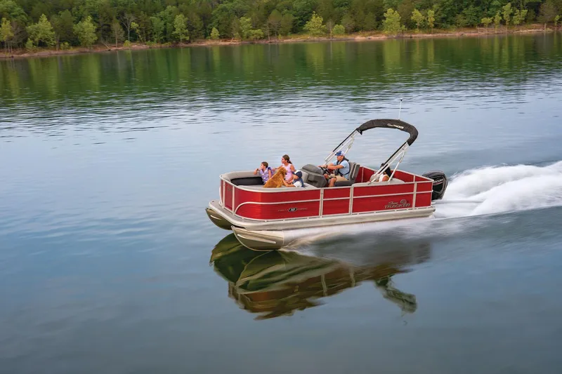 The Image of 2026 Sun Tracker Party Barge 18 DLX pontoon boat on trailer, parked outside. - 0