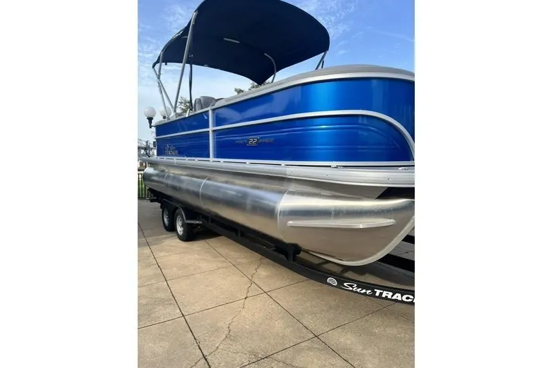 Slide: The Image of 2026 Sun Tracker Party Barge 22 XP3 pontoon boat with blue exterior on trailer. - 12