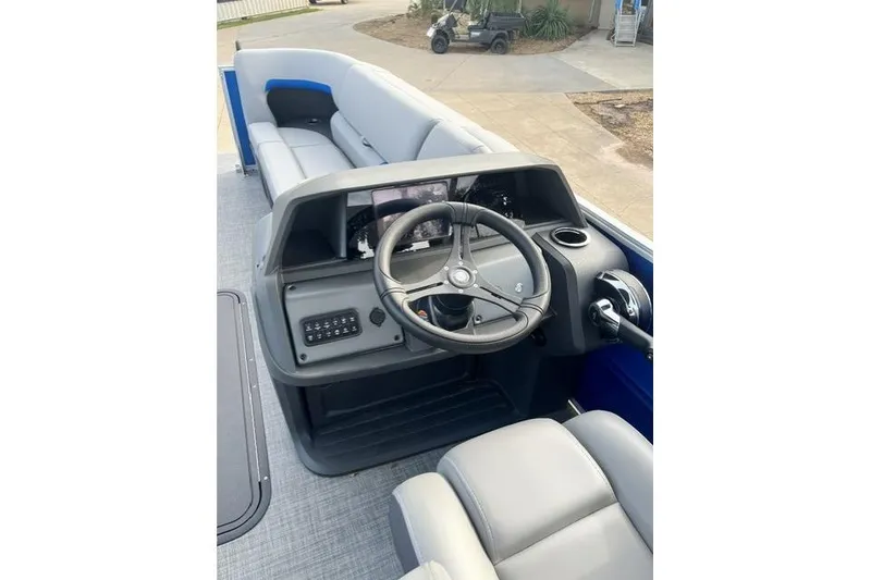 Slide: The Image of 2026 Sun Tracker Party Barge 22 XP3 interior with steering console and seating. - 6