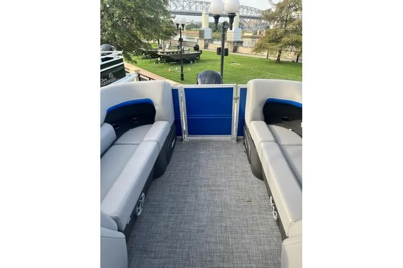Slide: The Image of 2026 Sun Tracker Party Barge 22 XP3 interior with gray seating and blue accents. - 7
