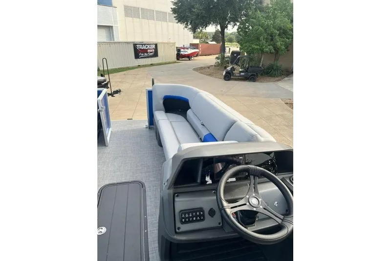 Slide: The Image of 2026 Sun Tracker Party Barge 22 XP3 interior with steering wheel and seating. - 5