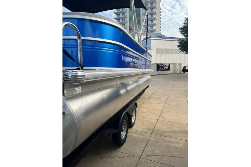Slide: The Image of 2026 Sun Tracker Party Barge 22 XP3 pontoon boat on trailer, urban background. - 93