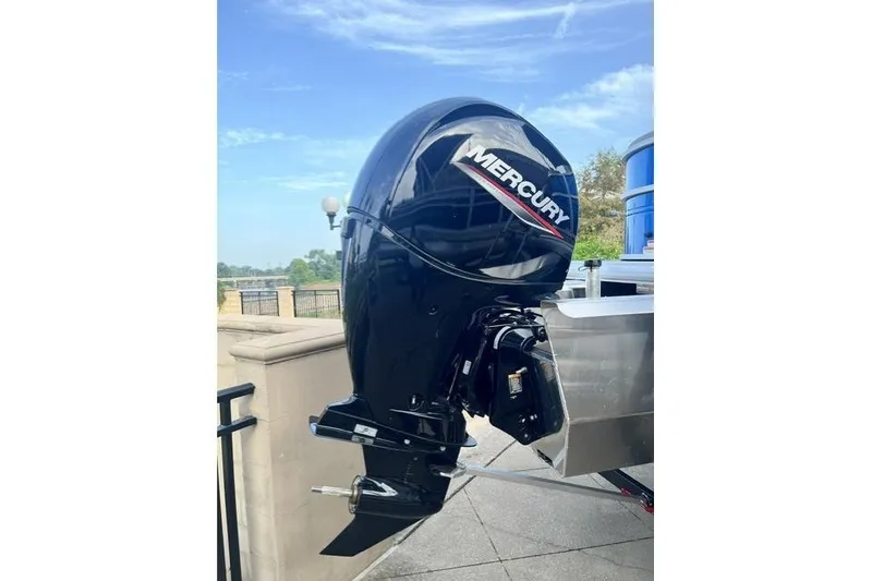 Slide: The Image of 2026 Sun Tracker Party Barge 22 XP3 with Mercury outboard motor, docked outdoors. - 10