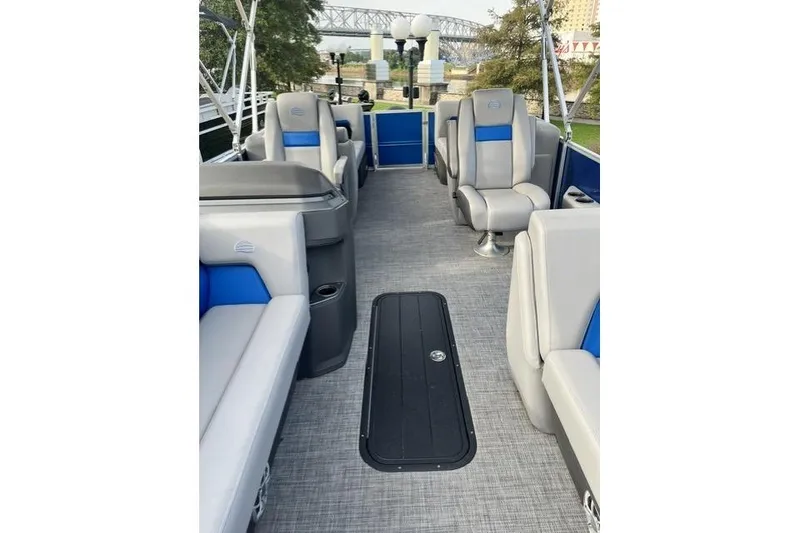 Slide: The Image of 2026 Sun Tracker Party Barge 22 XP3 interior with gray and blue seating, spacious layout. - 8