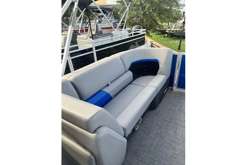 Slide: The Image of 2026 Sun Tracker Party Barge 22 XP3 with comfortable gray seating and blue accents. - 92