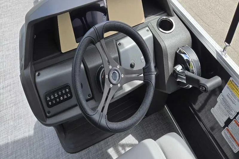 Slide: The Image of 2026 Sun Tracker Party Barge 22 DLX steering console with modern controls and cup holder. - 4