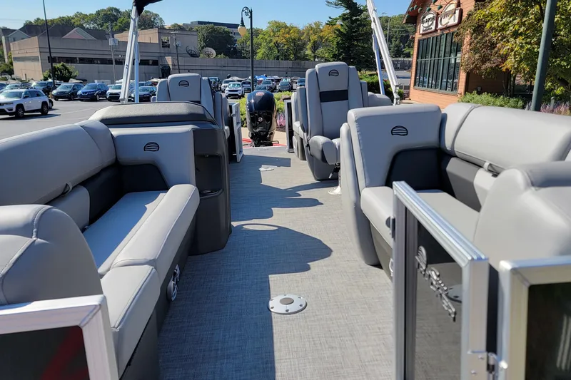 Slide: The Image of 2026 Sun Tracker Party Barge 22 DLX pontoon boat on trailer outside Outdoor World store. - 2