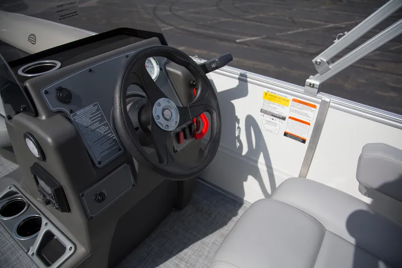 Slide: The Image of 2026 Sun Tracker Party Barge 16 DLX steering console with gauges and controls. - 3