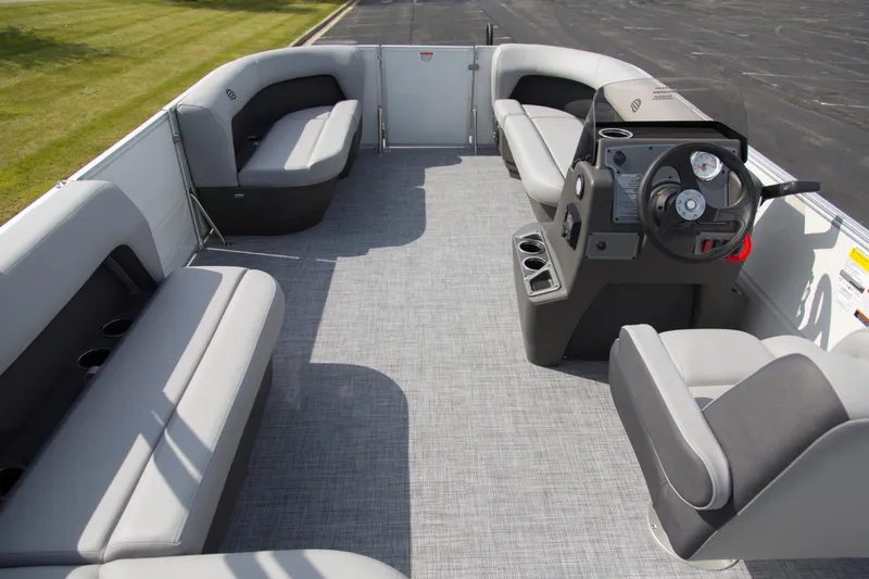 Slide: The Image of 2026 Sun Tracker Party Barge 16 DLX interior with spacious seating and modern helm. - 4