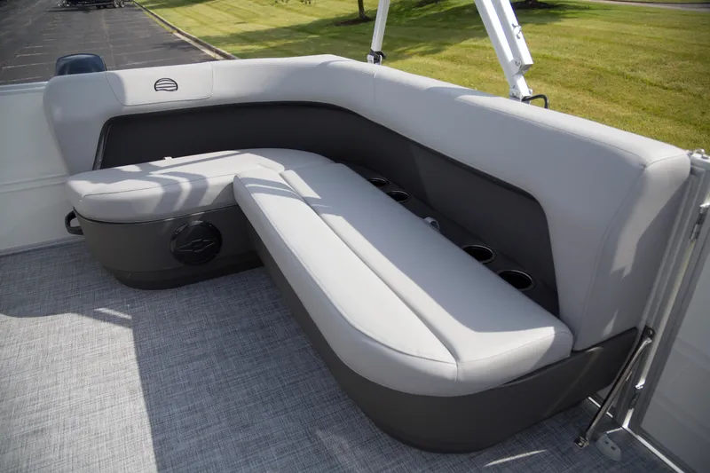 Slide: The Image of 2026 Sun Tracker Party Barge 16 DLX interior seating with cup holders and gray upholstery. - 5