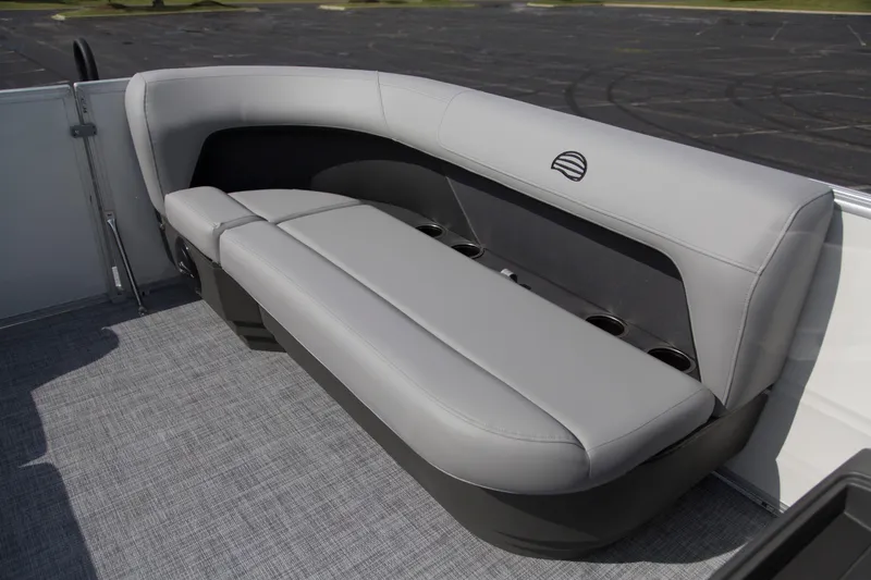 Slide: The Image of 2026 Sun Tracker Party Barge 16 DLX, featuring sleek gray seating and cup holders. - 6