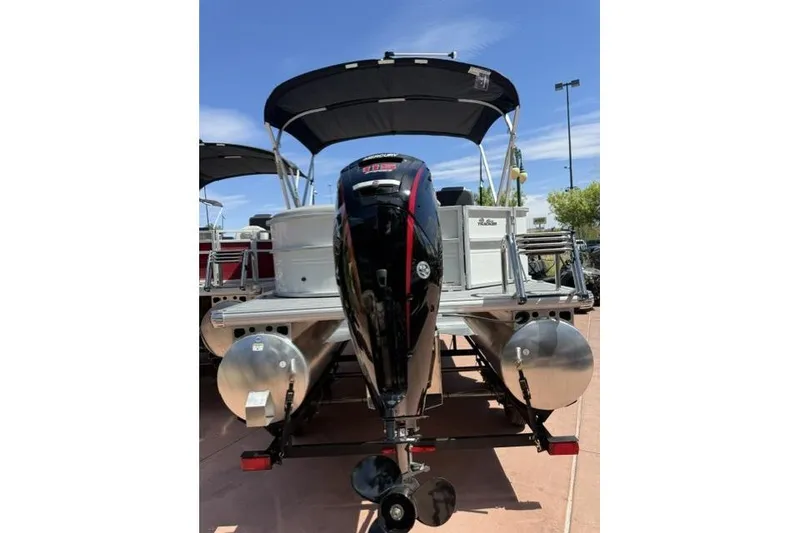 Slide: The Image of 2026 Sun Tracker Party Barge 20 DLX pontoon boat with outboard motor and canopy. - 2
