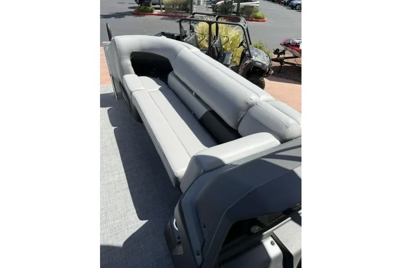 Slide: The Image of 2026 Sun Tracker Party Barge 20 DLX with spacious gray seating on deck. - 5