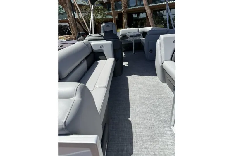 Slide: The Image of 2026 Sun Tracker Party Barge 20 DLX interior with gray seating and flooring. - 8