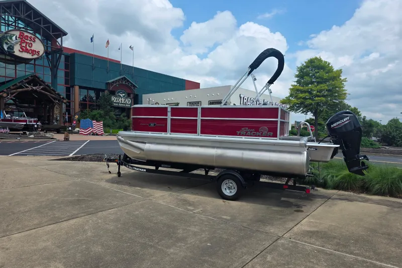 Slide: The Image of 2026 Sun Tracker Party Barge 16 DLX pontoon boat outside Bass Pro Shops. - 45