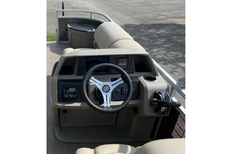 Slide: The Image of 2026 Sun Tracker Party Barge 16 DLX steering console with modern controls and comfortable seating. - 3