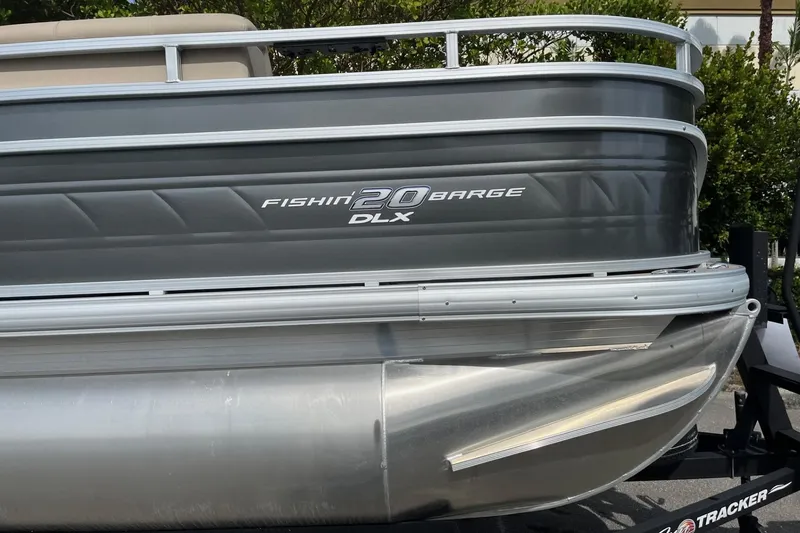 Slide: The Image of 2026 Sun Tracker Party Barge 16 DLX pontoon boat, side view with "Fishin' Barge 20 DLX" text. - 51