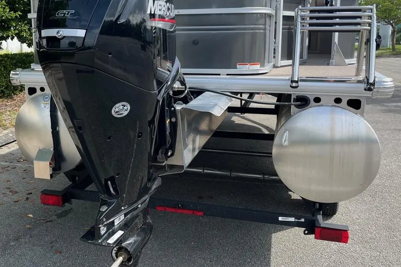 Slide: The Image of 2026 Sun Tracker Party Barge 16 DLX with Mercury outboard motor, rear view. - 6