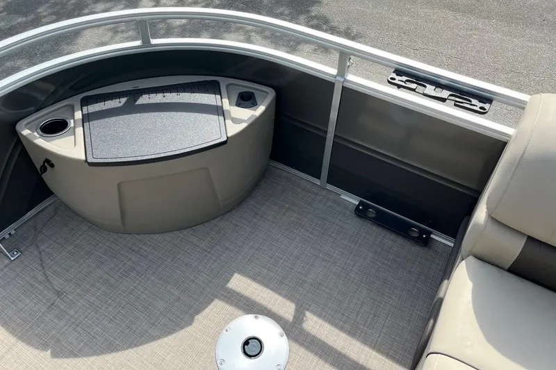 Slide: The Image of 2026 Sun Tracker Party Barge 16 DLX interior with seating and storage area. - 8