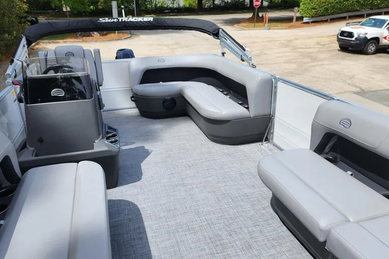 Slide: The Image of 2026 Sun Tracker Party Barge 16 DLX interior with gray seating and helm. - 5