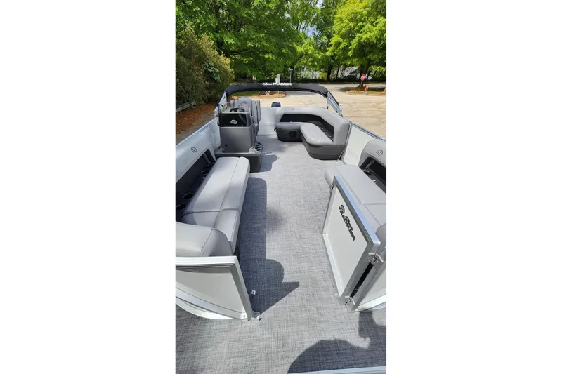Slide: The Image of 2026 Sun Tracker Party Barge 16 DLX interior with gray seating and open deck space. - 7