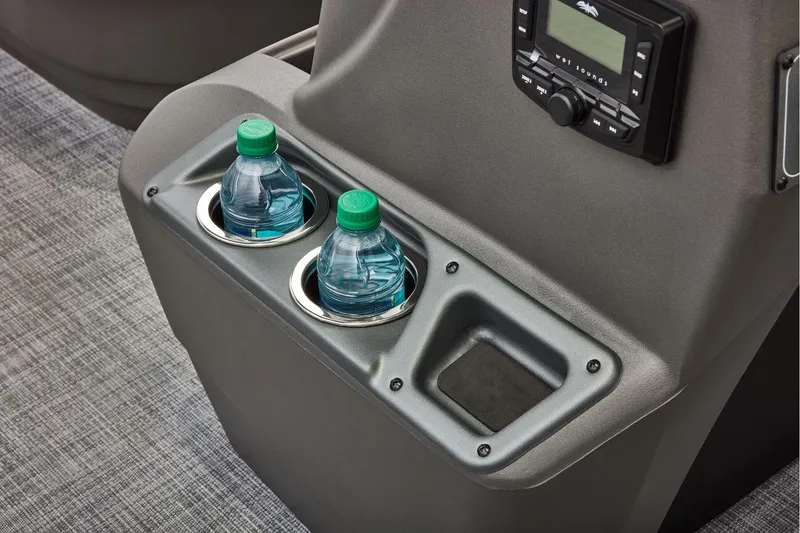 Slide: The Image of 2026 Sun Tracker Party Barge 16 DLX interior storage compartment with cup holders. - 19