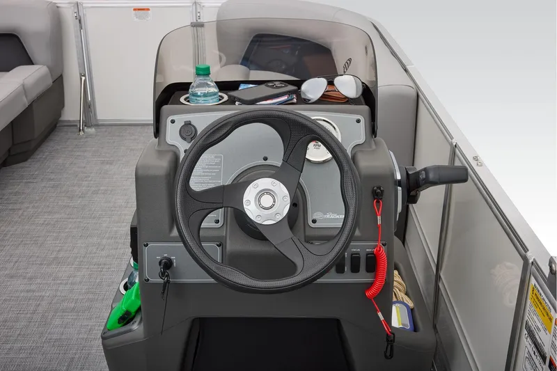 Slide: The Image of 2026 Sun Tracker Party Barge 16 DLX interior with gray seating and cup holders. - 20