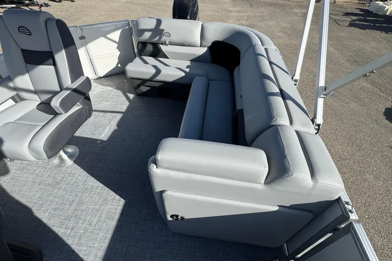 Slide: The Image of 2026 Sun Tracker Party Barge 20 DLX interior with gray seating and flooring. - 10