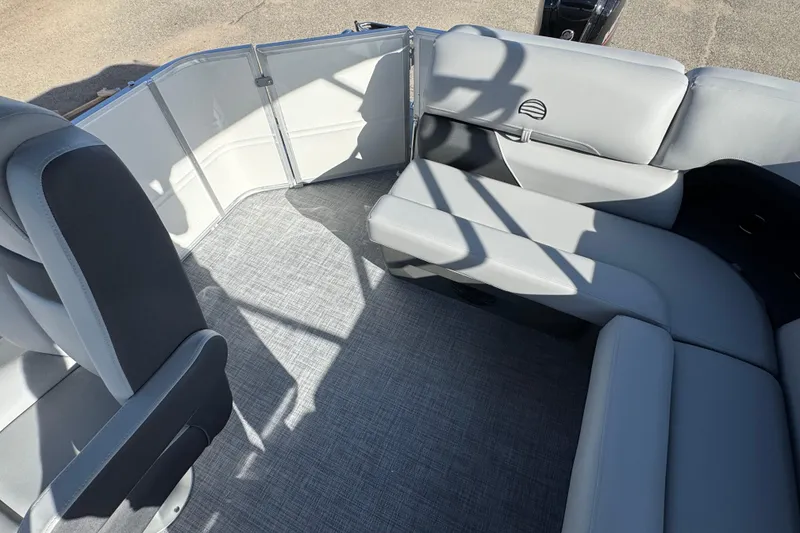 Slide: The Image of 2026 Sun Tracker Party Barge 20 DLX interior with gray seating and flooring. - 13