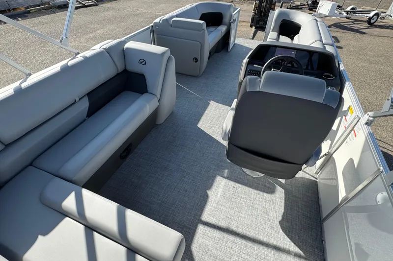 Slide: The Image of 2026 Sun Tracker Party Barge 20 DLX interior with spacious seating and modern helm. - 15
