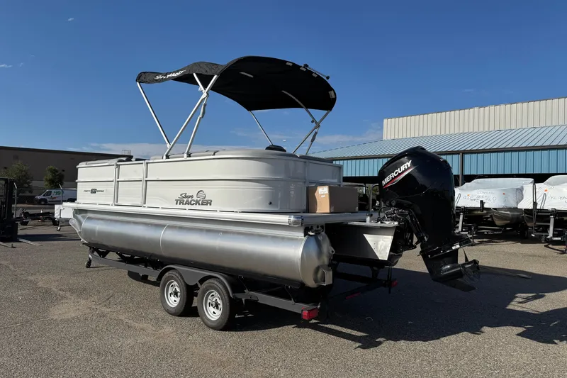 Slide: The Image of 2026 Sun Tracker Party Barge 20 DLX pontoon boat with Mercury engine on trailer. - 2