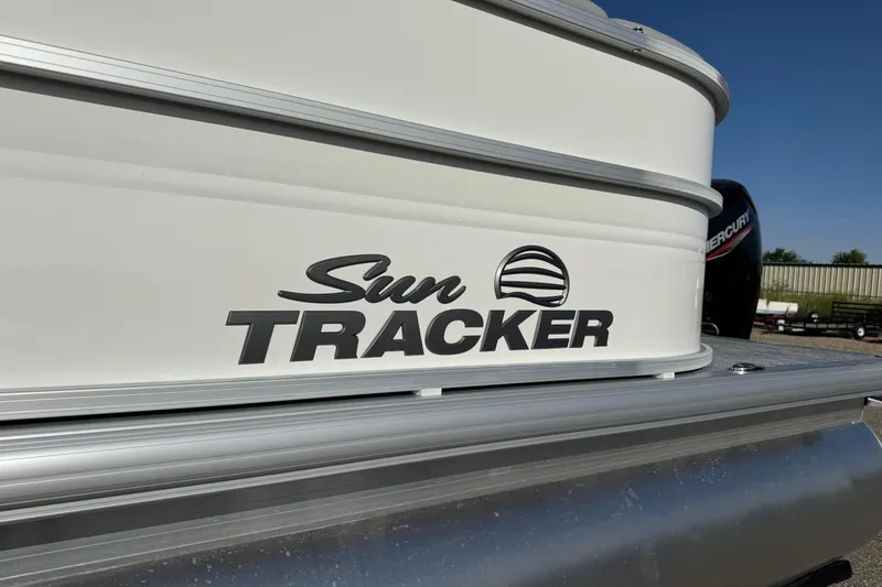 Slide: The Image of 2026 Sun Tracker Party Barge 20 DLX logo on boat exterior. - 5