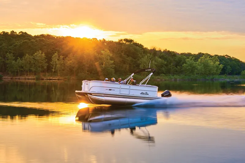 The Image of 2026 Sun Tracker Party Barge 22 XP3 pontoon boat on trailer, red and silver design. - 0