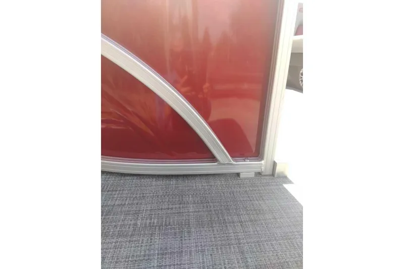 Slide: The Image of 2026 Sun Tracker Party Barge 22 XP3, red paneling and gray flooring detail. - 83