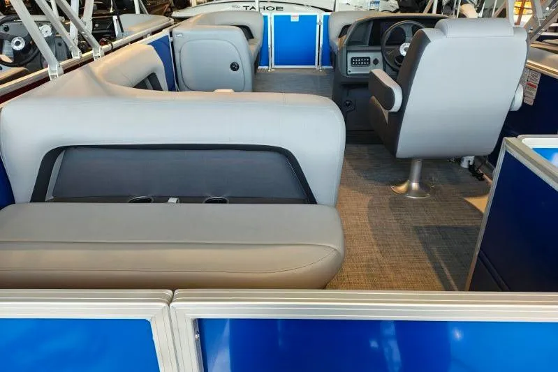 Slide: The Image of 2026 Sun Tracker Party Barge 18 DLX interior with seating and steering console. - 12