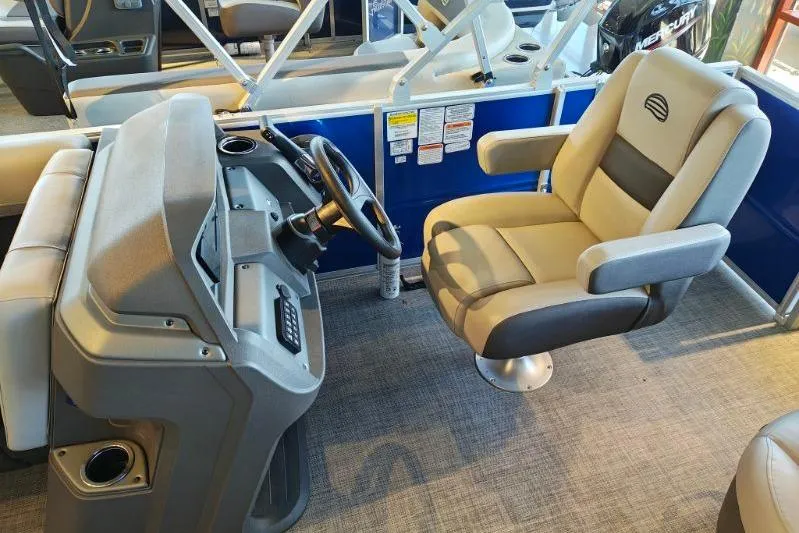 Slide: The Image of 2026 Sun Tracker Party Barge 18 DLX interior with steering console and captain's chair. - 15