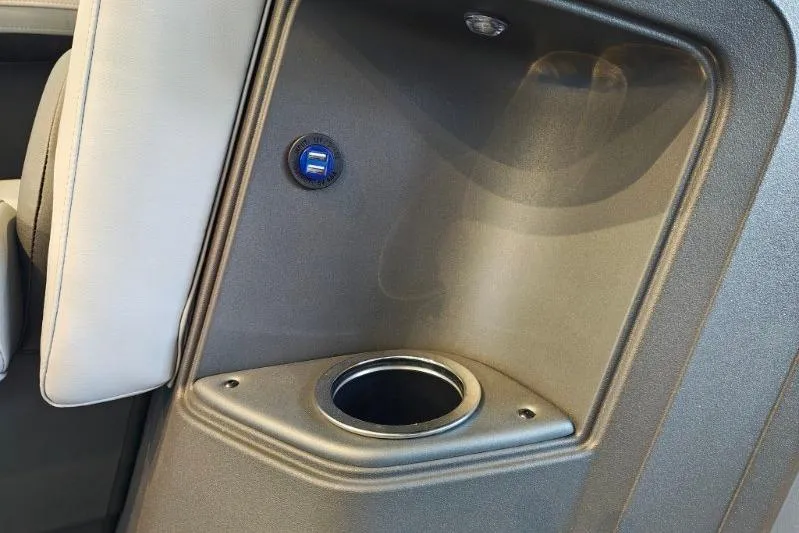 Slide: The Image of 2026 Sun Tracker Party Barge 18 DLX interior with cup holder and USB port. - 6