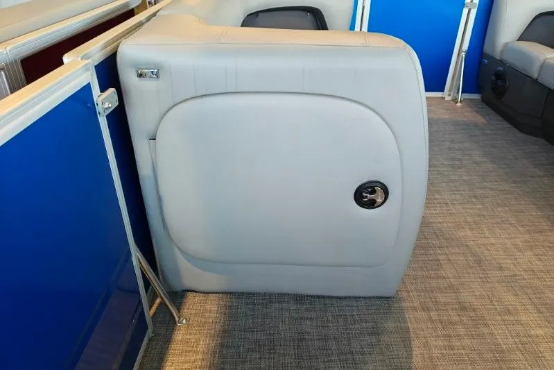 Slide: The Image of 2026 Sun Tracker Party Barge 18 DLX interior seating with blue paneling and gray upholstery. - 8