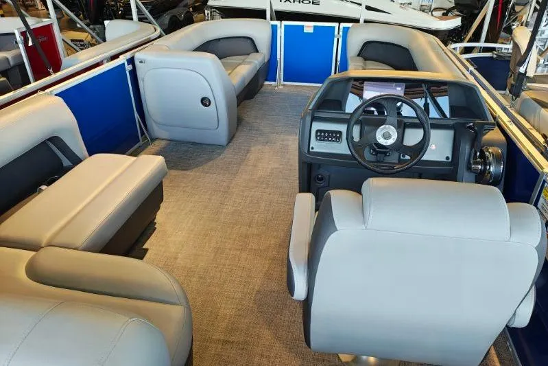 Slide: The Image of 2026 Sun Tracker Party Barge 18 DLX interior with plush seating and modern helm. - 9