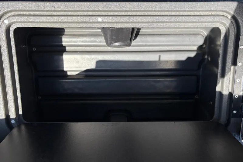 Slide: The Image of Storage compartment of 2026 Sun Tracker Party Barge 20 DLX, showcasing interior space. - 36