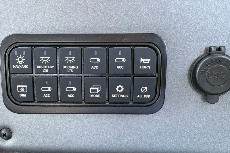 Slide: The Image of Control panel of 2026 Sun Tracker Party Barge 20 DLX with various function buttons. - 26