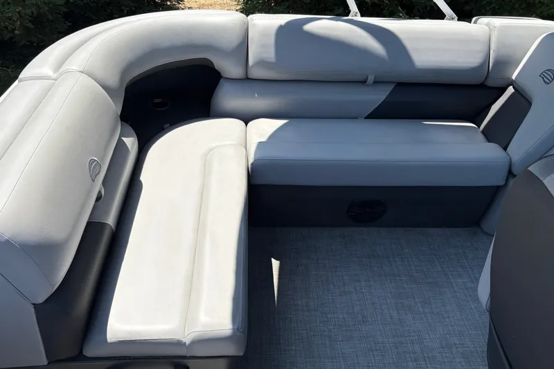 Slide: The Image of 2026 Sun Tracker Party Barge 20 DLX interior seating with gray upholstery. - 19