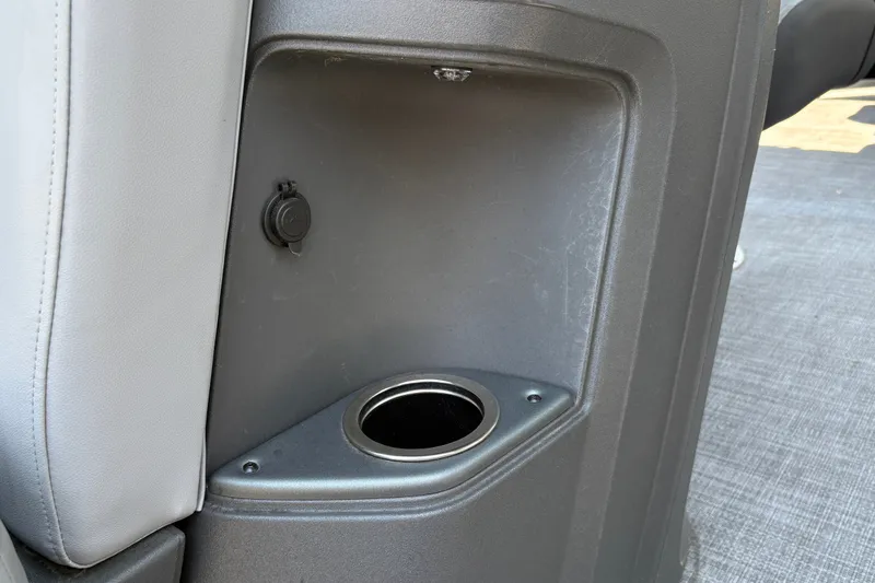 Slide: The Image of 2026 Sun Tracker Party Barge 20 DLX interior cup holder and storage compartment. - 28