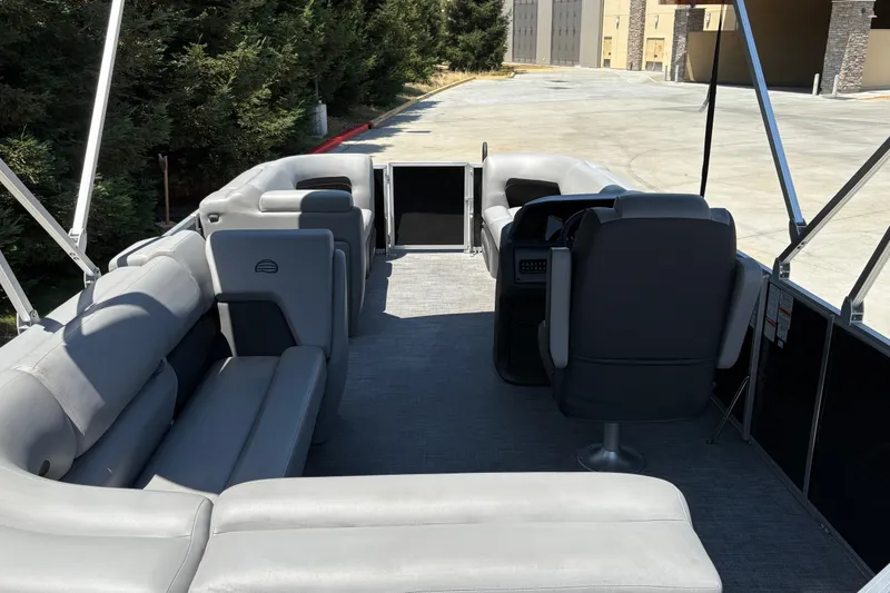 Slide: The Image of 2026 Sun Tracker Party Barge 20 DLX interior with gray seating and spacious layout. - 13