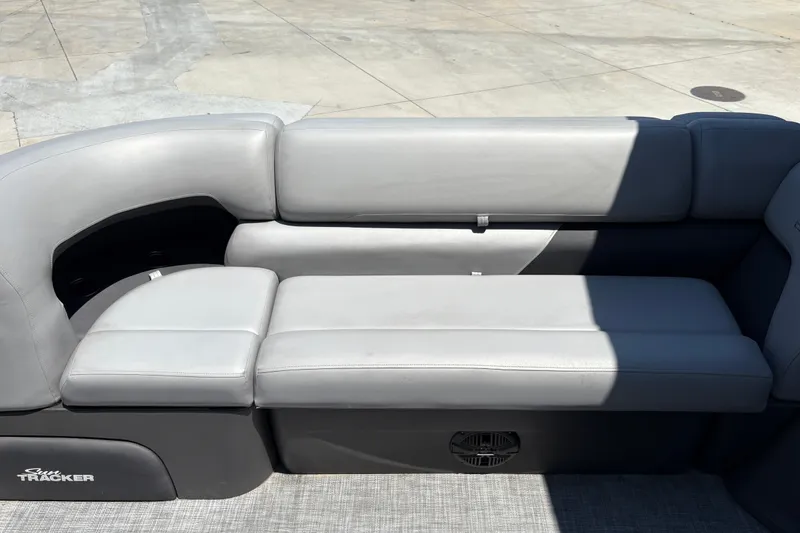 Slide: The Image of 2026 Sun Tracker Party Barge 20 DLX, featuring sleek gray seating on a pontoon boat. - 18