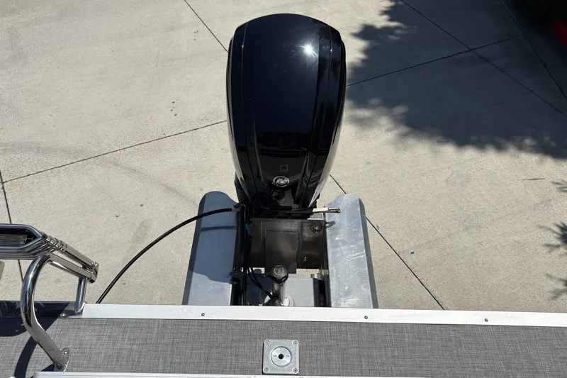 Slide: The Image of 2026 Sun Tracker Party Barge 20 DLX outboard motor on concrete surface. - 15