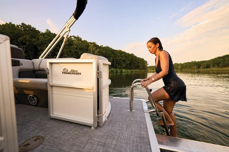 Slide: The Image of 2026 Sun Tracker Party Barge 22 XP3 interior seating with gray upholstery and cup holders. - 17