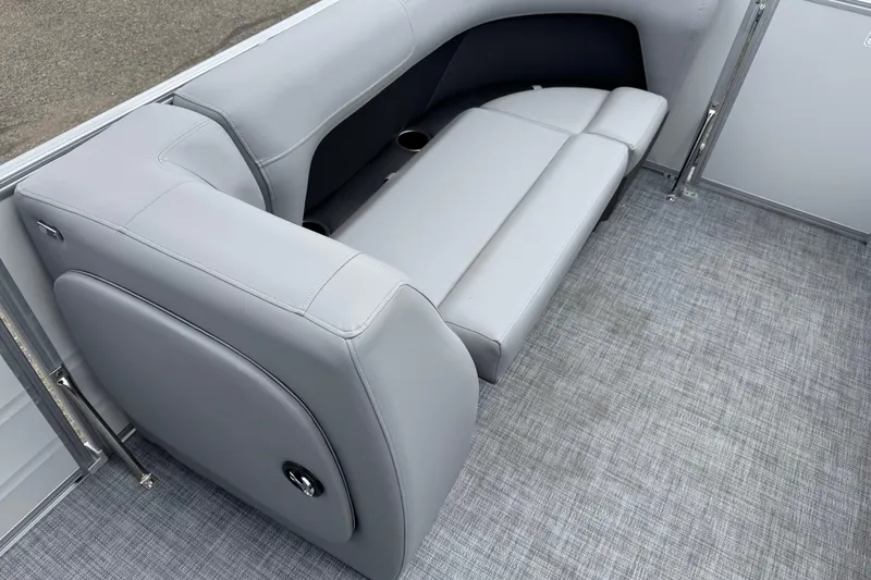Slide: The Image of 2026 Sun Tracker Party Barge 16 DLX interior seating with gray upholstery and cup holders. - 13