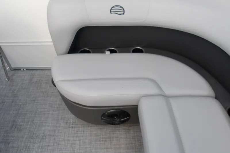 Slide: The Image of 2026 Sun Tracker Party Barge 16 DLX interior seating with cup holders and speaker. - 17